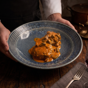 Pimientos del Piquillo Rellenos de Caza con Salsa Romescu a la Sidra y Bechamel de Queso La Peral